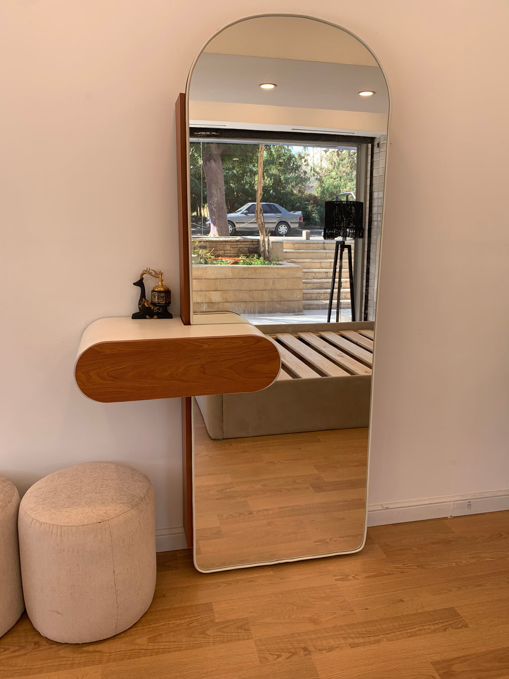 A shoe cabinet with a mirror