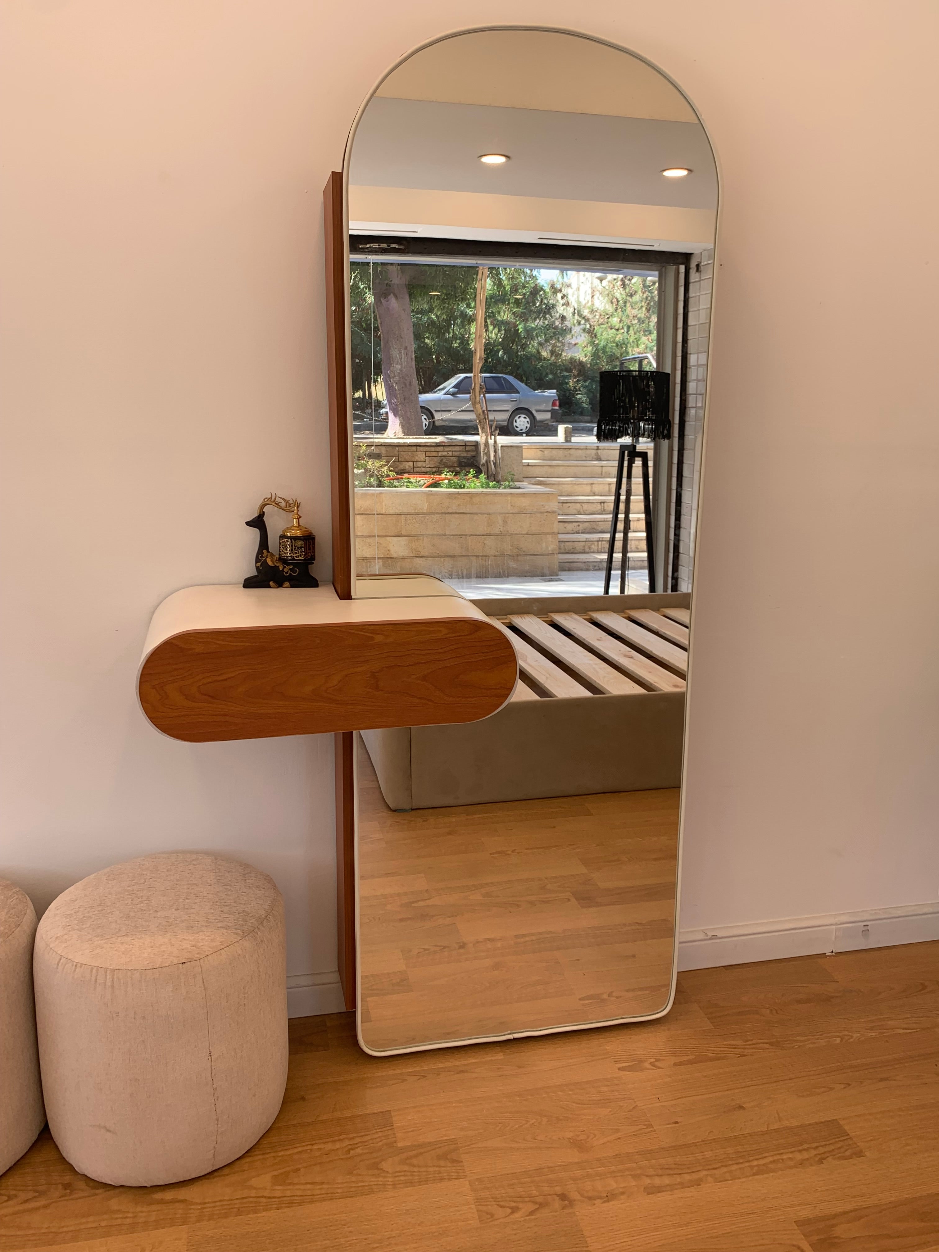 A shoe cabinet with a mirror