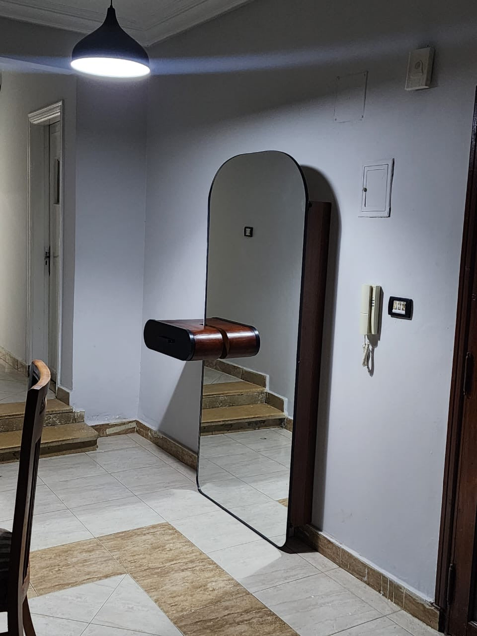 A shoe cabinet with a mirror