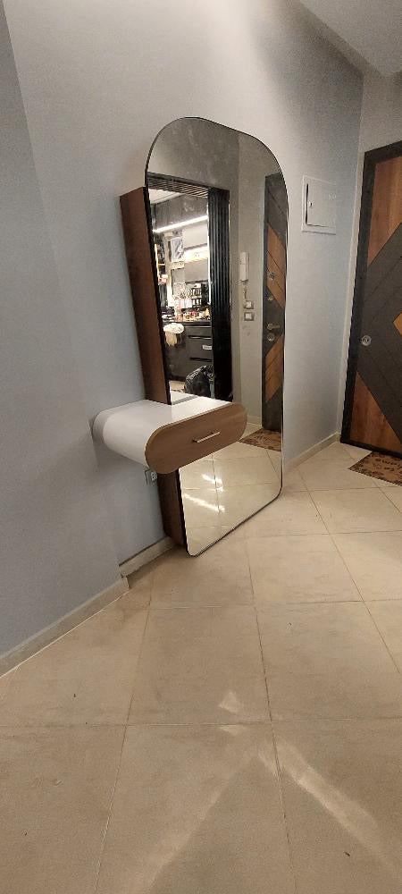 A shoe cabinet with a mirror