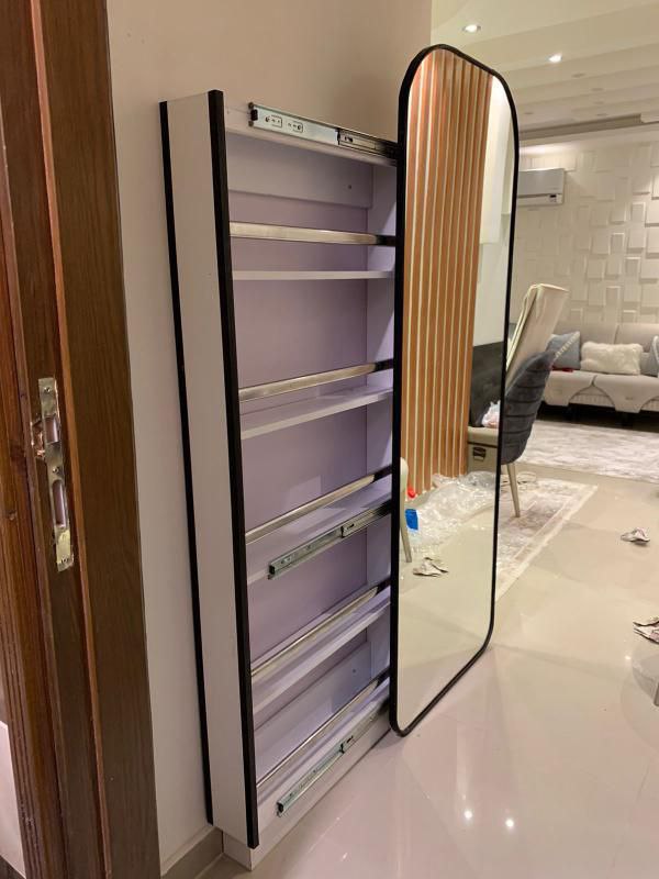 A shoe cabinet with a mirror