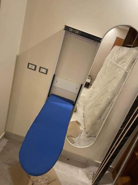 Ironing wall unit with mirror.
