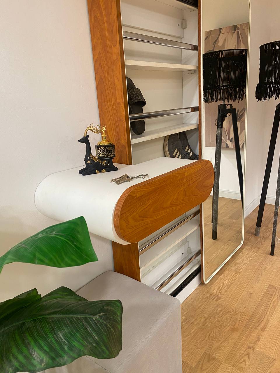 A shoe cabinet with a mirror