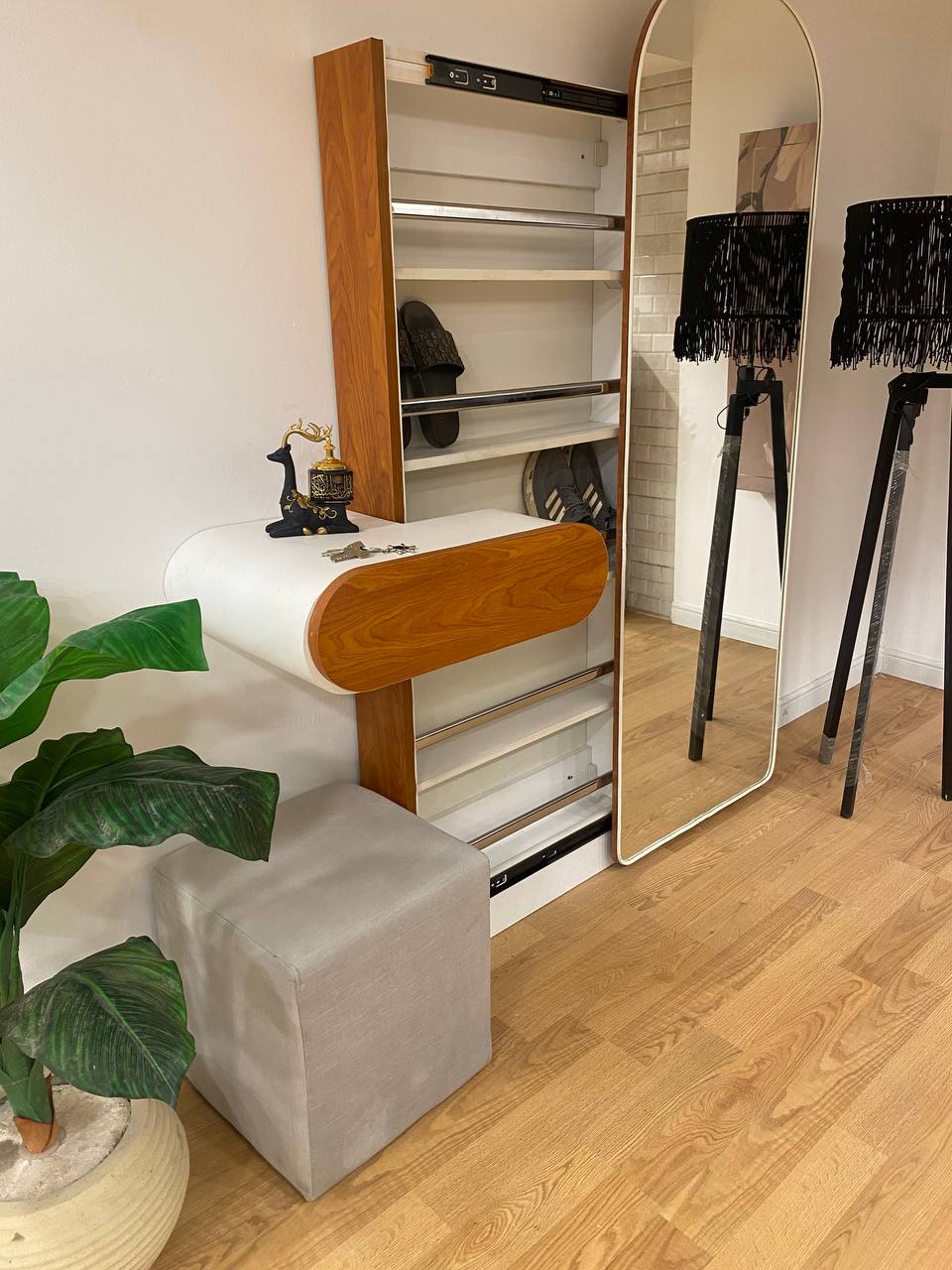 A shoe cabinet with a mirror