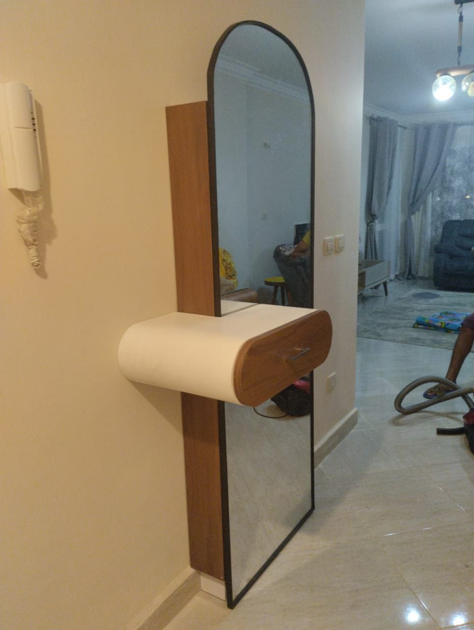 A shoe cabinet with a mirror
